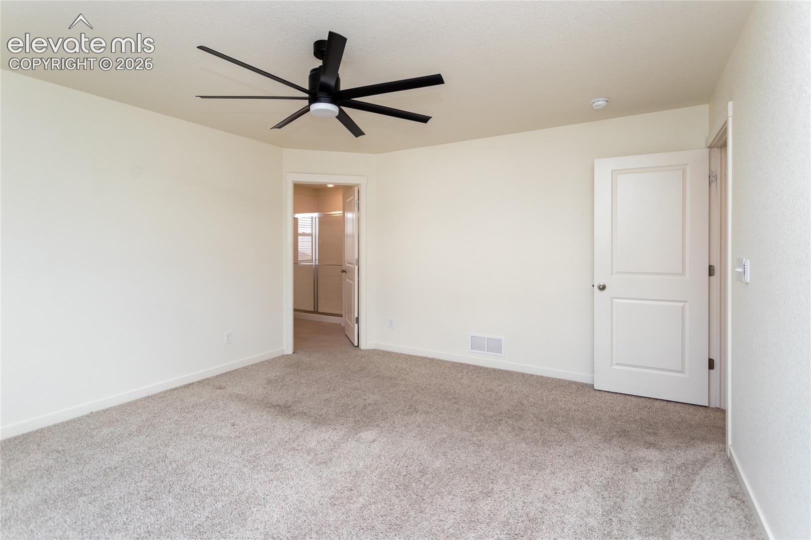 Another view of the primary bedroom