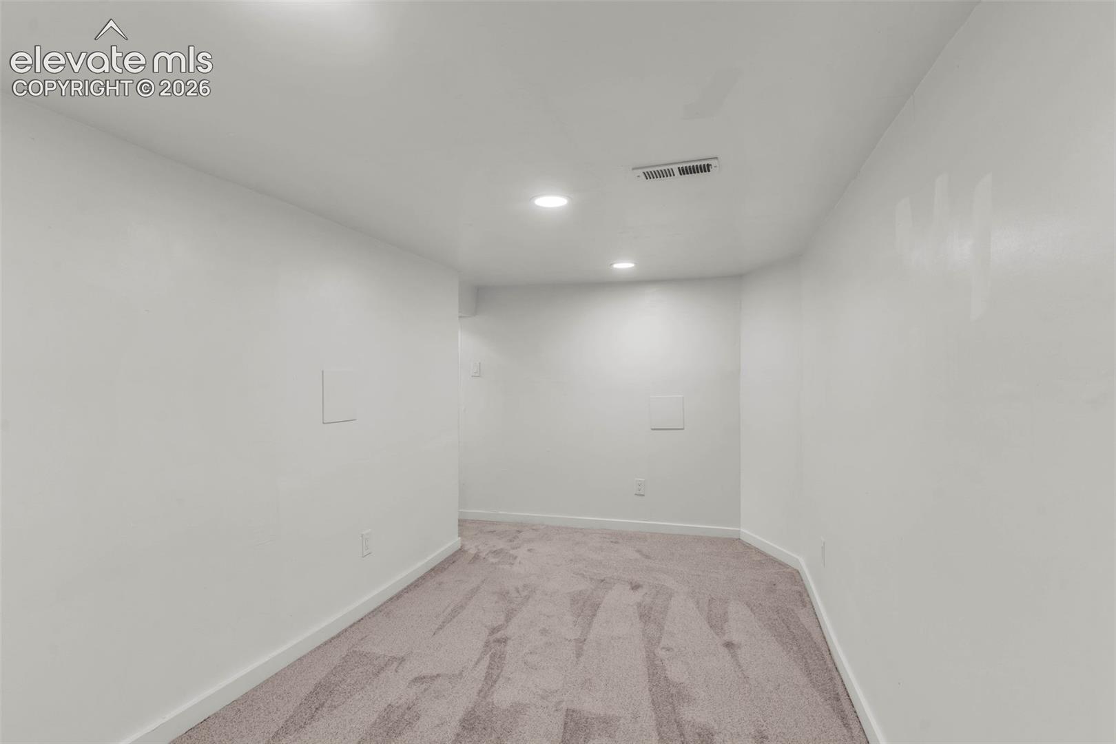 Interior space featuring neutral wall paint, wall-to-wall carpeting, and recessed ceiling lighting