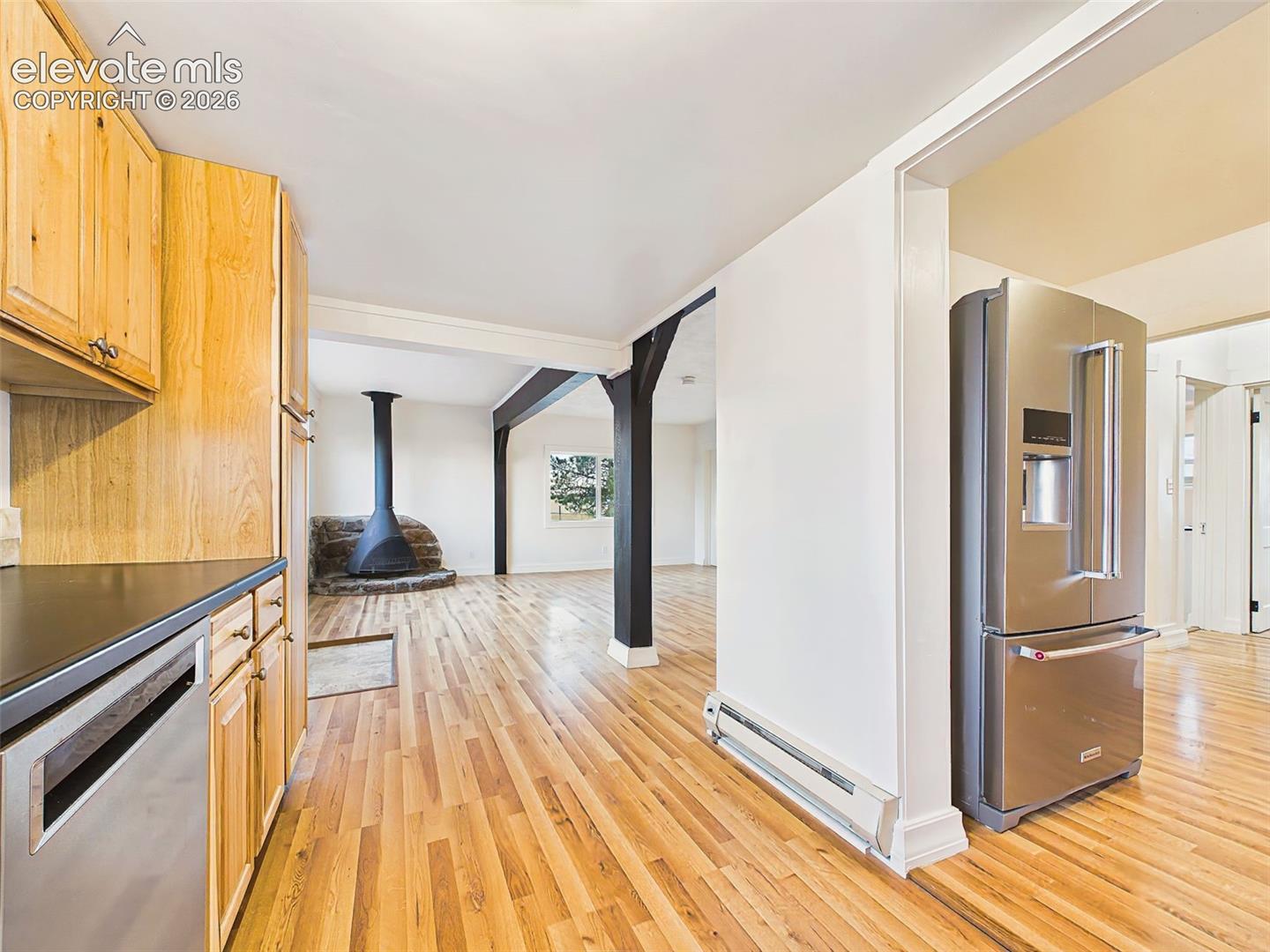 Kitchen opens seamlessly to the great room, offering an efficient layout with abundant cabinetry, updated finishes, and easy flow for everyday living.