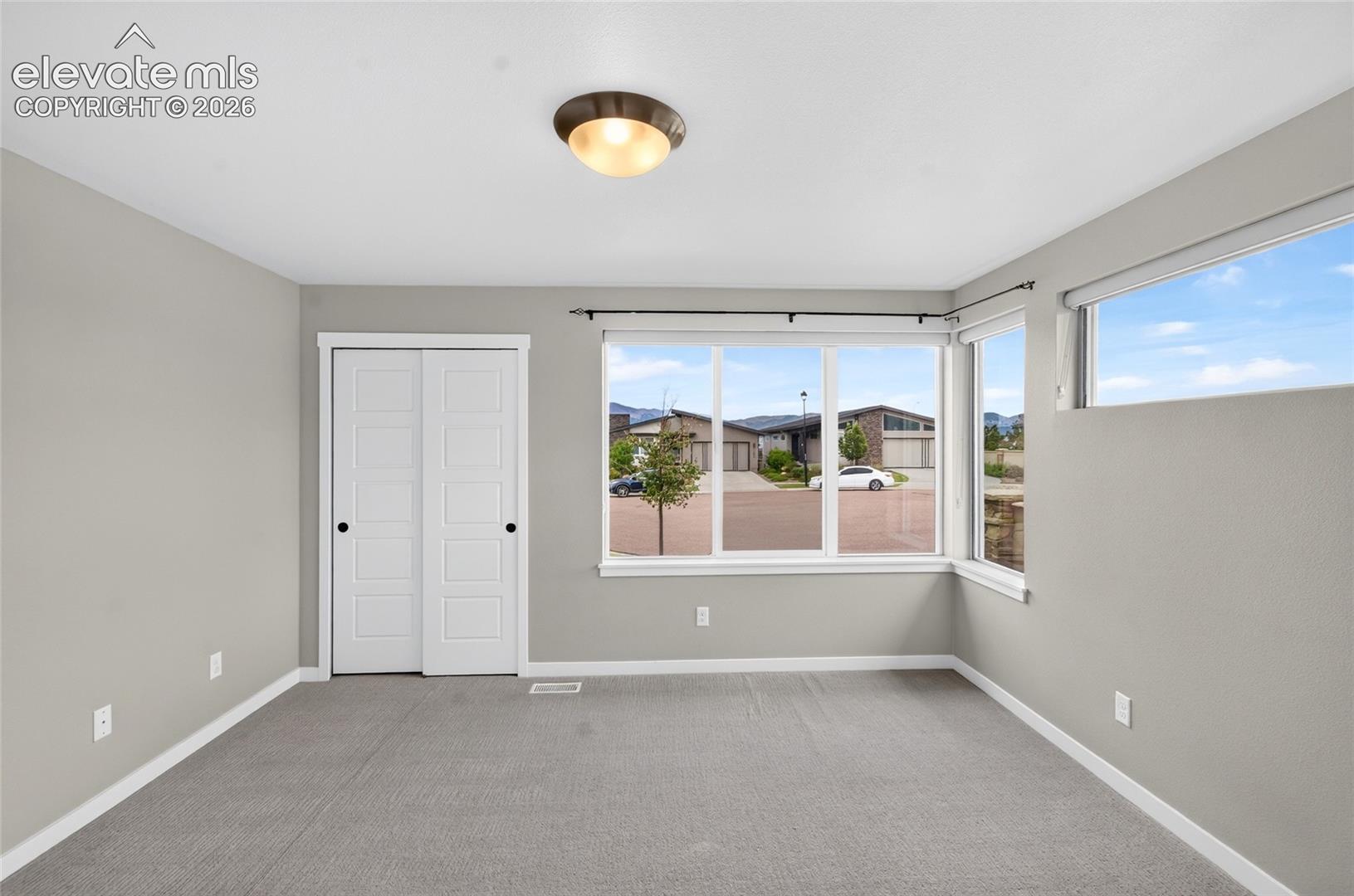 Main floor bedroom with view of mountains Expansive multi-pane window system with corner orientation