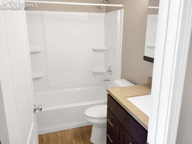 Full bath with vanity, shower / tub combination, and wood finish floors