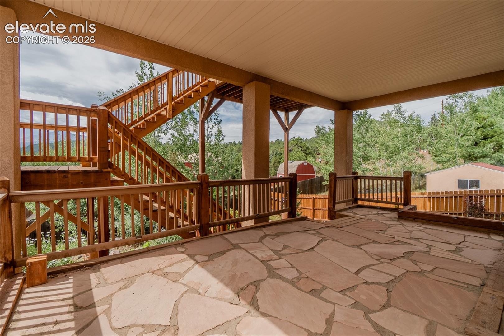 Exceptional outdoor living with multiple covered flagstone patios, creating the perfect setting to relax, entertain, and enjoy the surrounding mountain scenery.