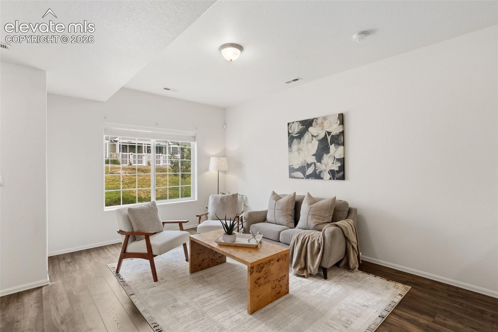 This bright and airy living space is a blank canvas ready for your personal touch, featuring modern six-panel doors and great natural light