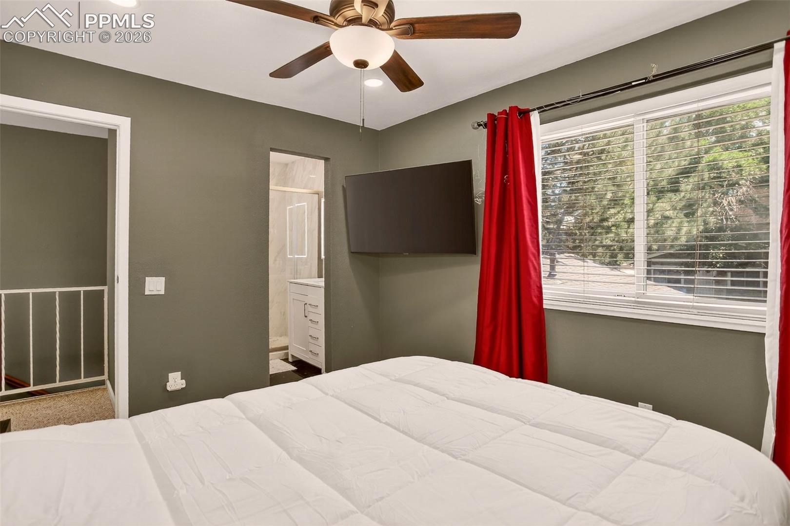 "The primary bedroom features an en-suite bathroom, built-in shelving, fresh paint, and brand-new carpet." 