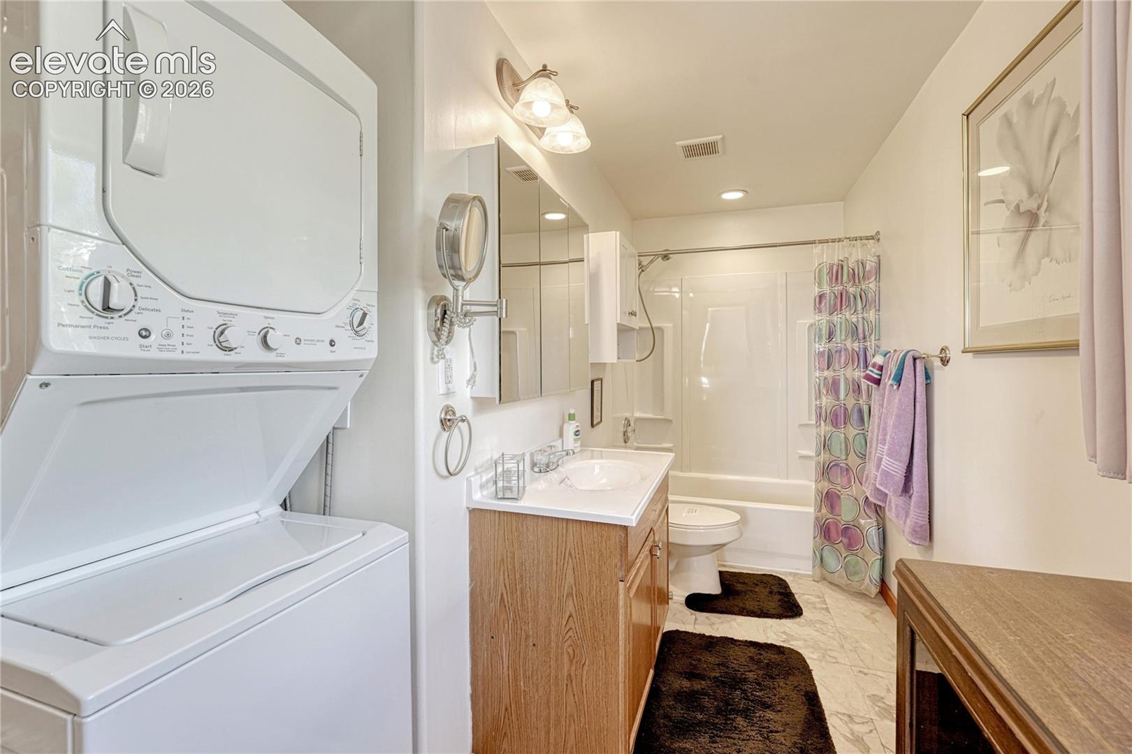 Bathroom with washer and dryer