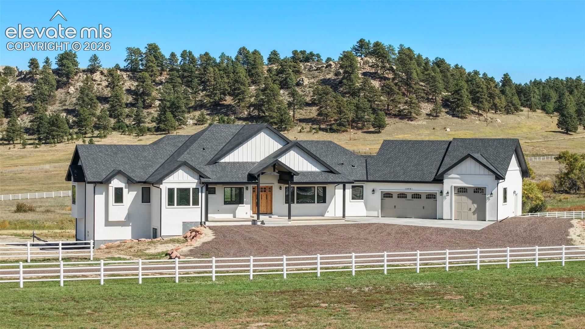 Contemporary farmhouse exterior with white siding and dark trim