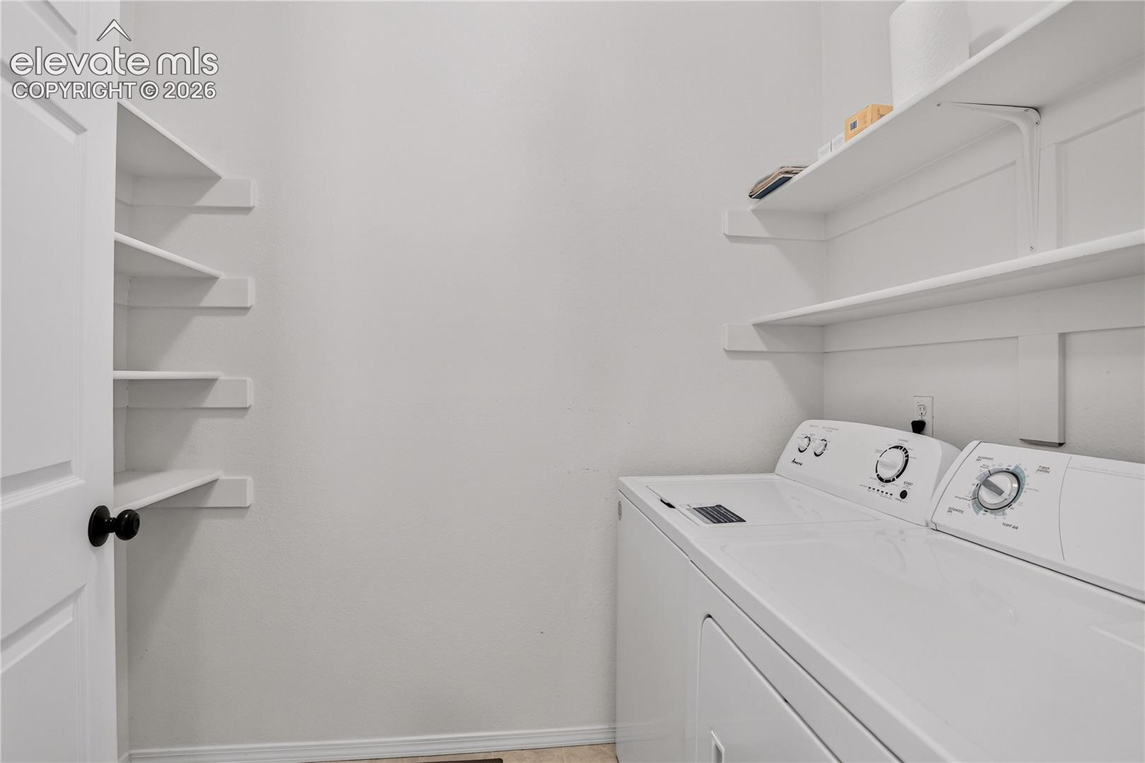 Laundry room with ample shelving space. 