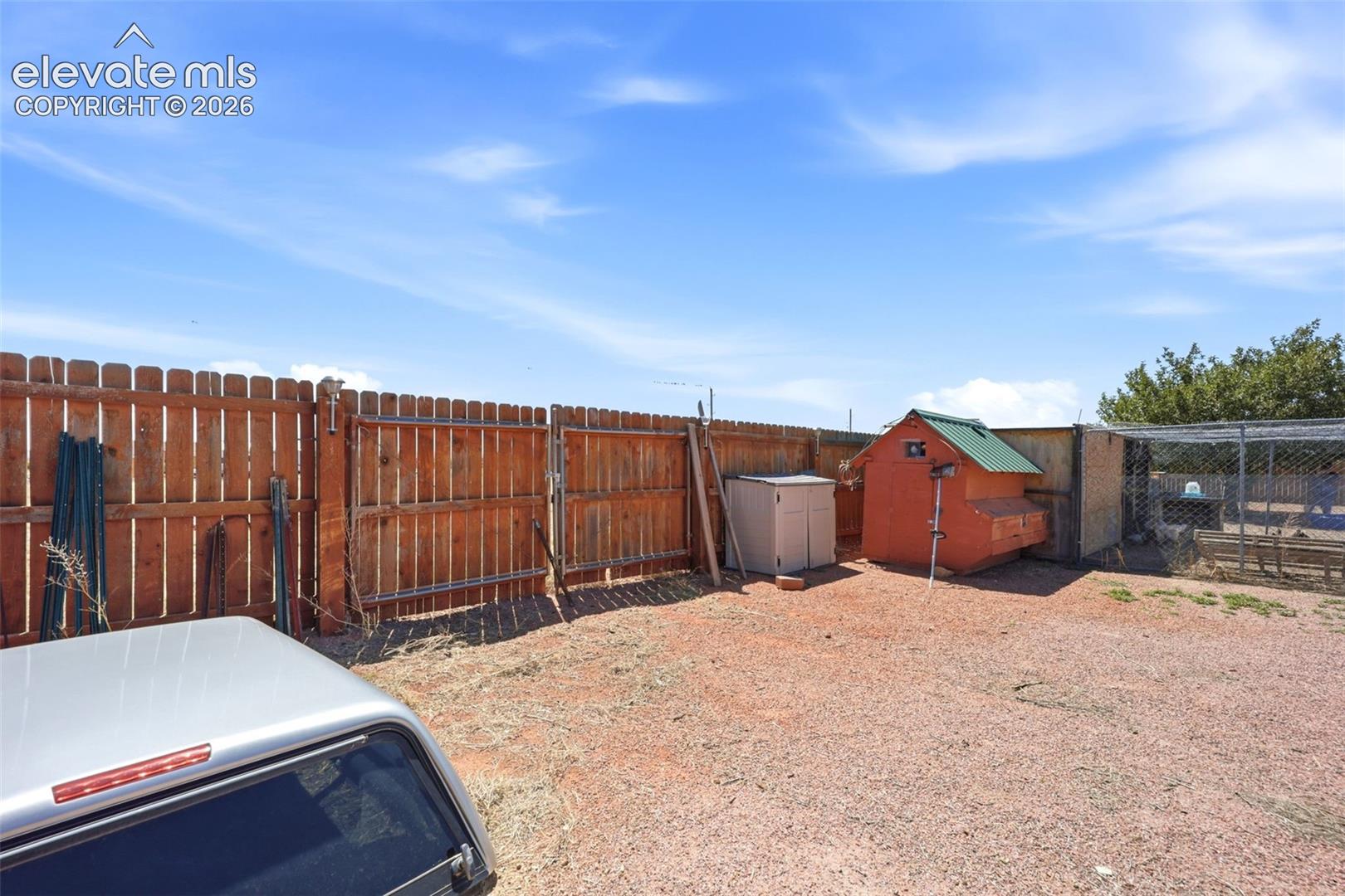 Enclosed backyard with a full wood privacy fence and gate access