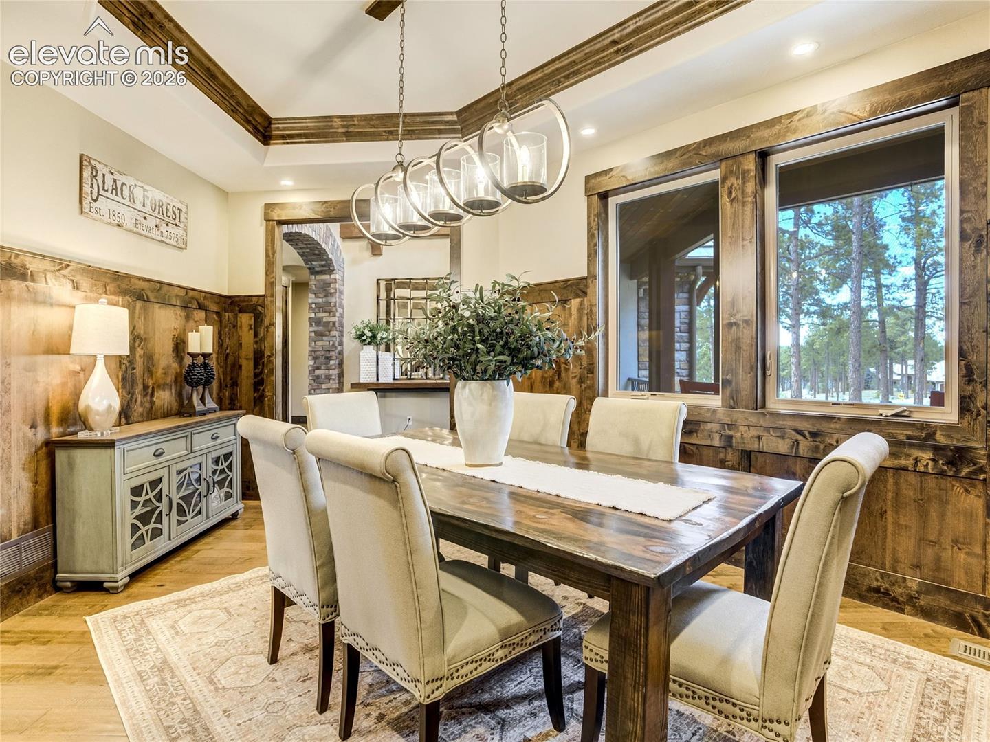 Layered with rustic wood detailing, the dining room becomes a warm gathering space for celebrating life’s meaningful moments.