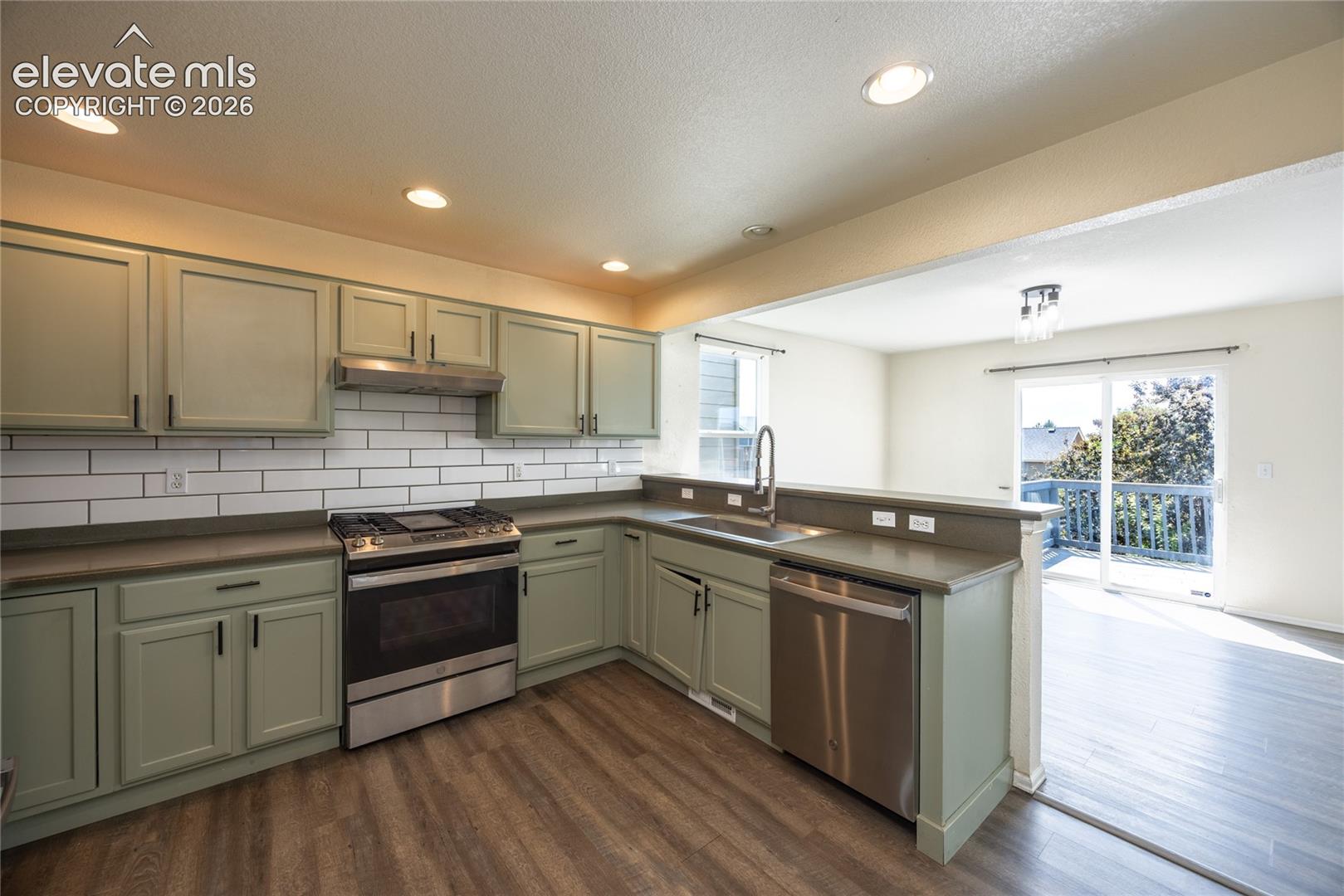 Kitchen featuring wood-finish flooring, recessed lighting, and stainless steel appliances