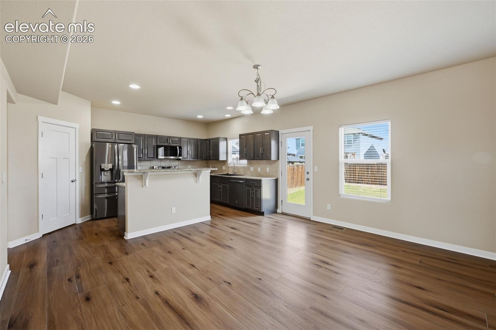The dining area sits conveniently between the kitchen and living room for an easy, connected main-level flow.