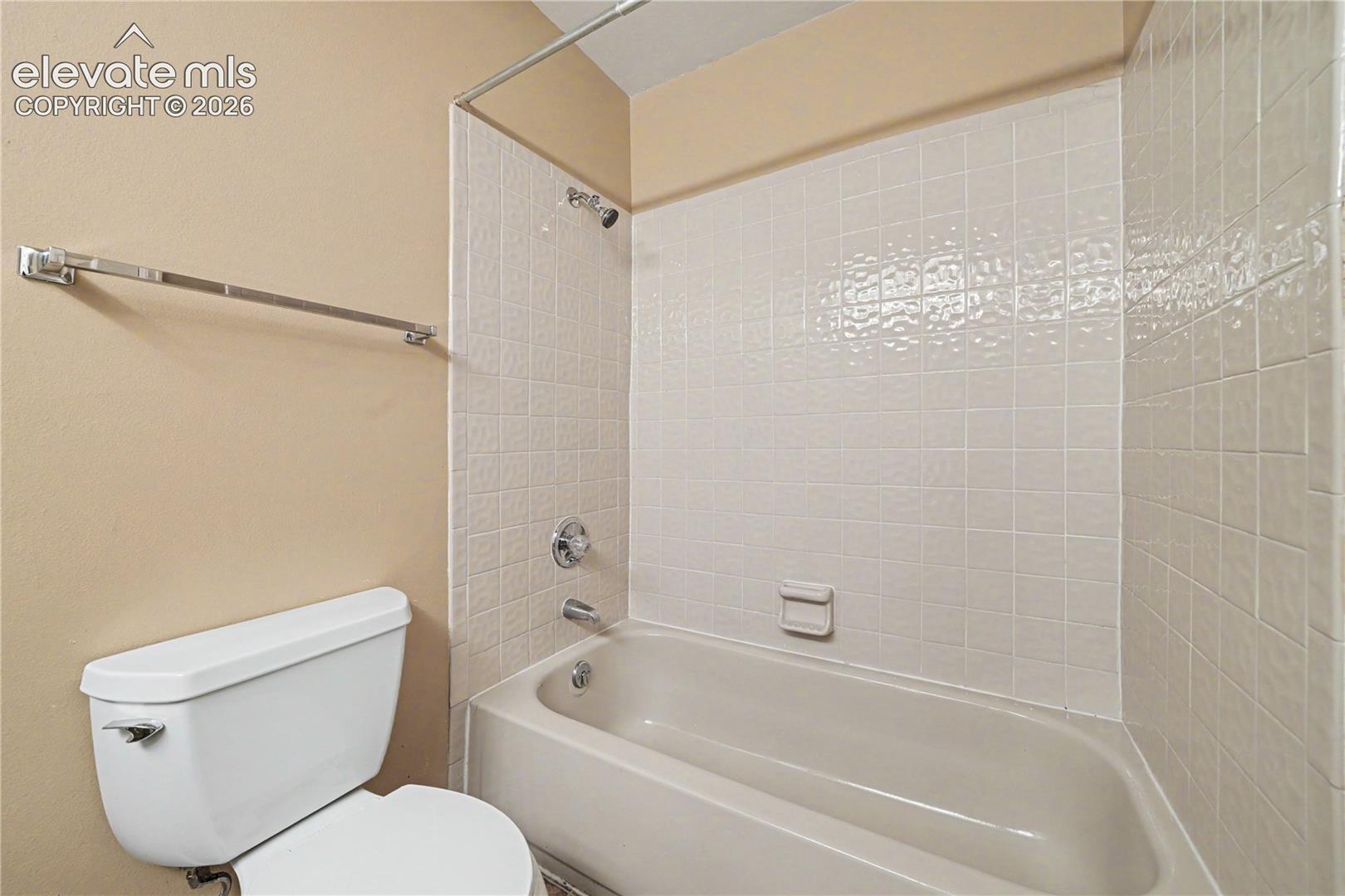 Bathroom with toilet and tiled shower area