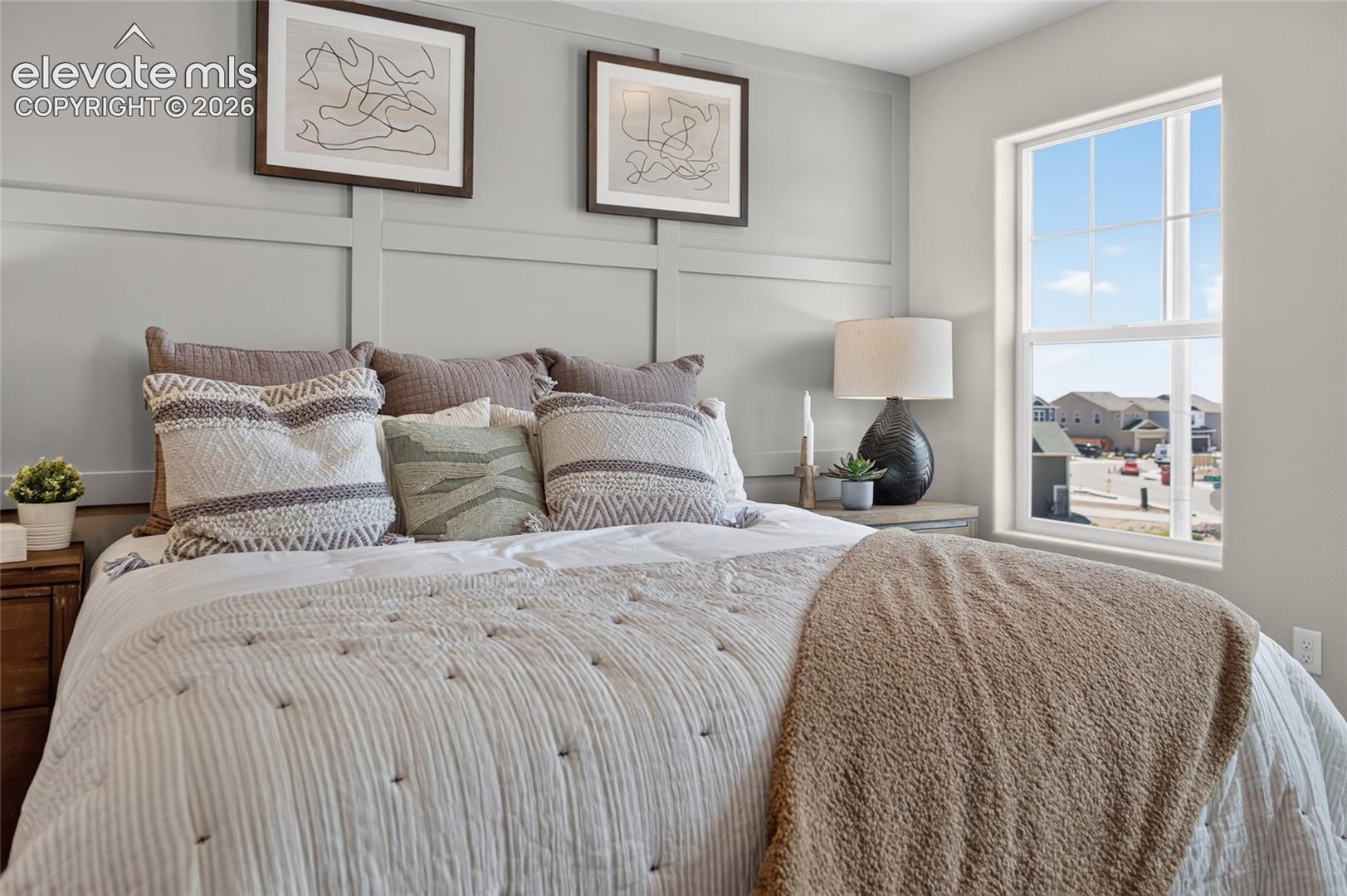 Wall-mounted grid millwork, neutral interior paint, and a single-hung window with a grid pattern