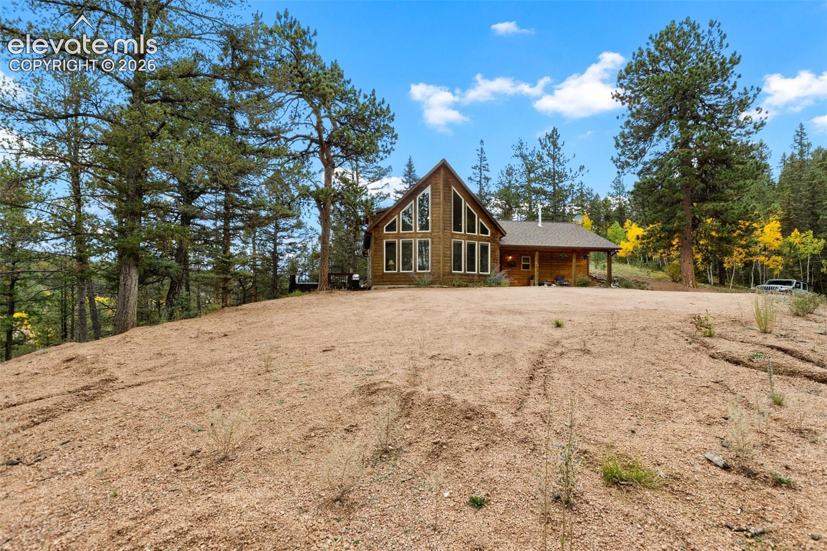 Exterior featuring a gabled roofline, abundant window design, and a covered front porch