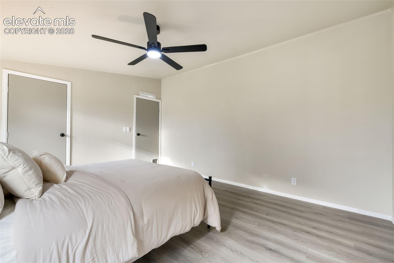 Light gray walls complement the wood-finish flooring