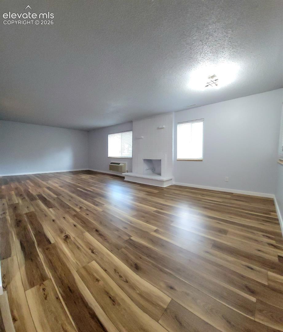 Spacious living area featuring wood-finish flooring throughout
