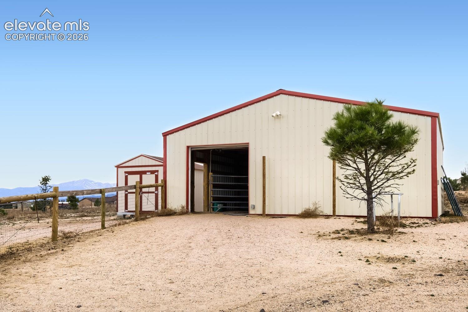Large barn with two stalls and a large work station/tack room. 