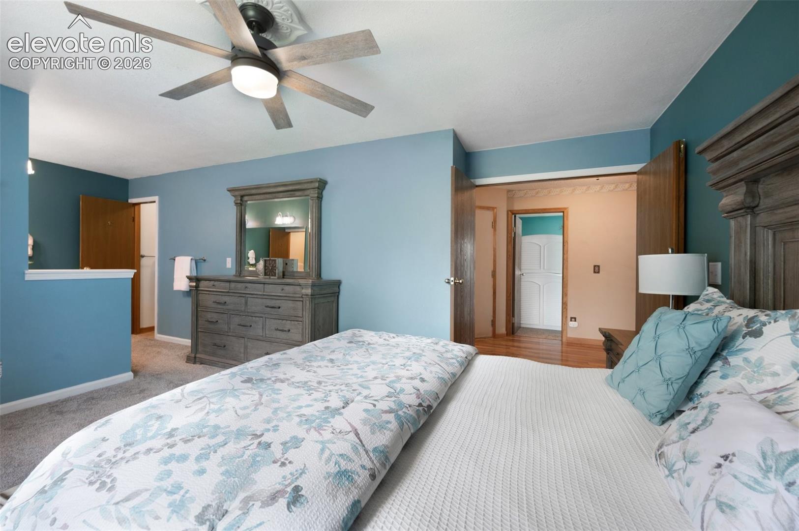 Bedroom featuring baseboards, carpet floors, and ceiling fan