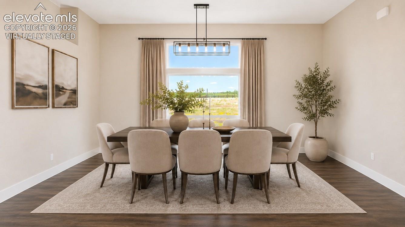 Virtually Staged Dining area featuring a contemporary linear chandelier, large picture window with transom, wood-finish flooring, and neutral wall tones