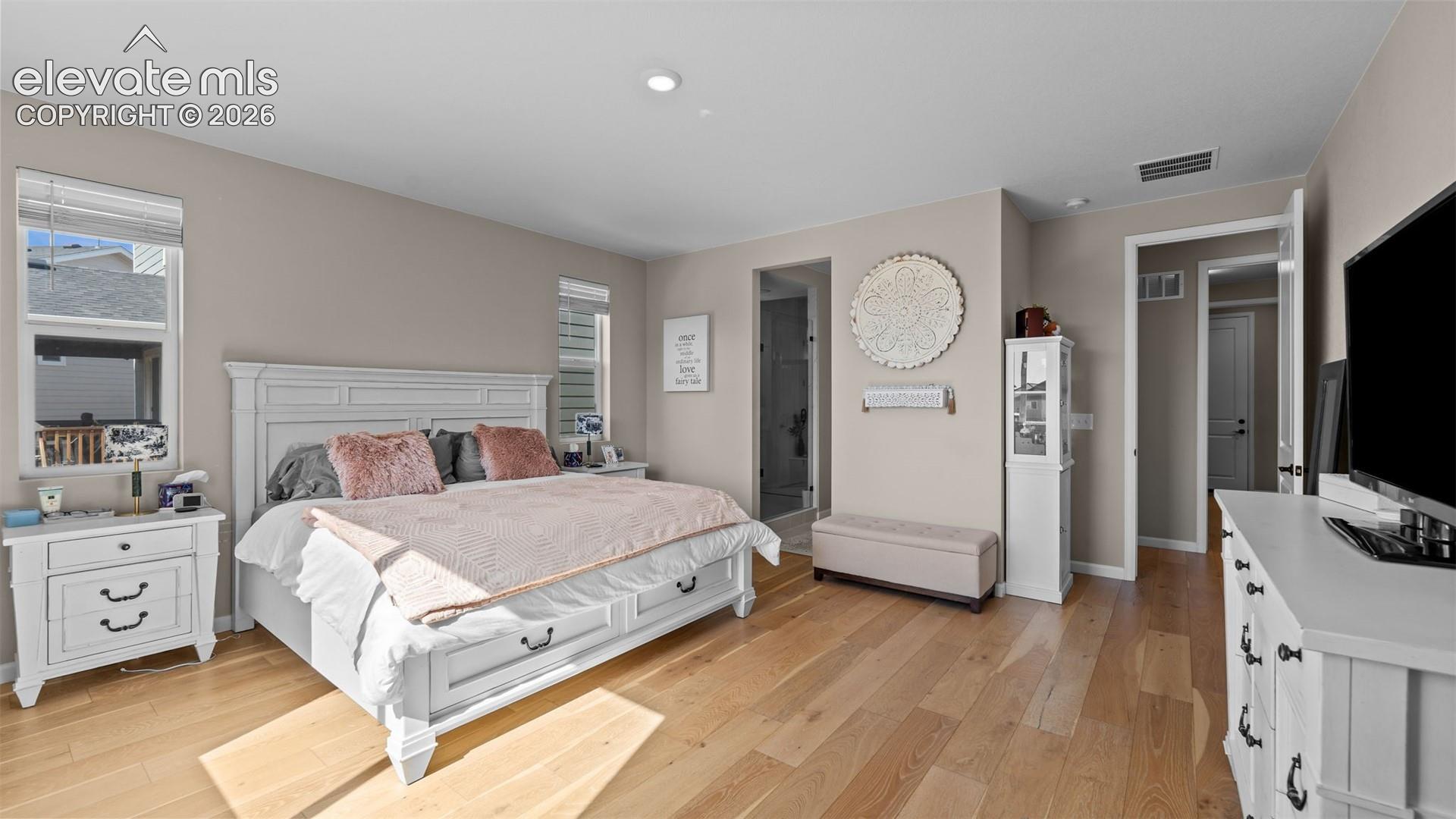 Hardwood-finish flooring, recessed lighting, and neutral wall tones