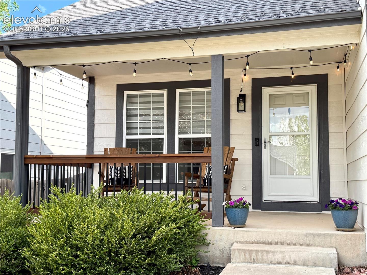 Front covered porch featuring , white siding, and dark trim