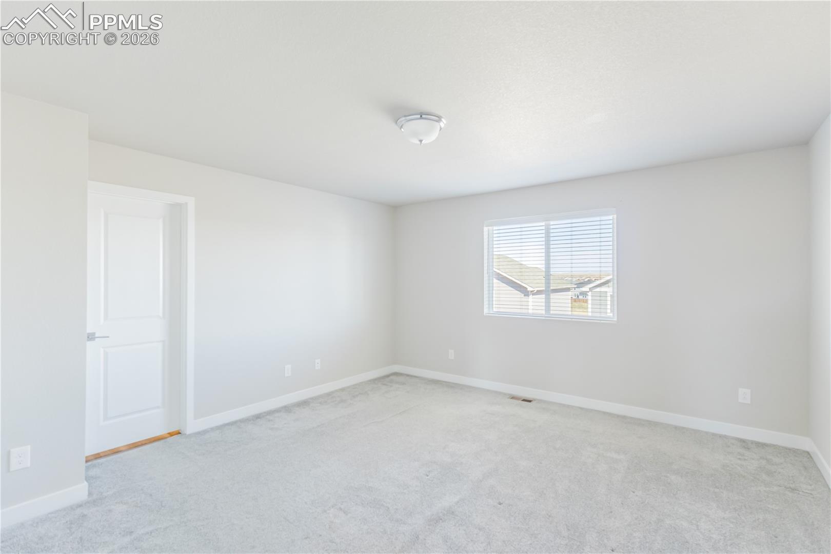 Spare room with light colored carpet
