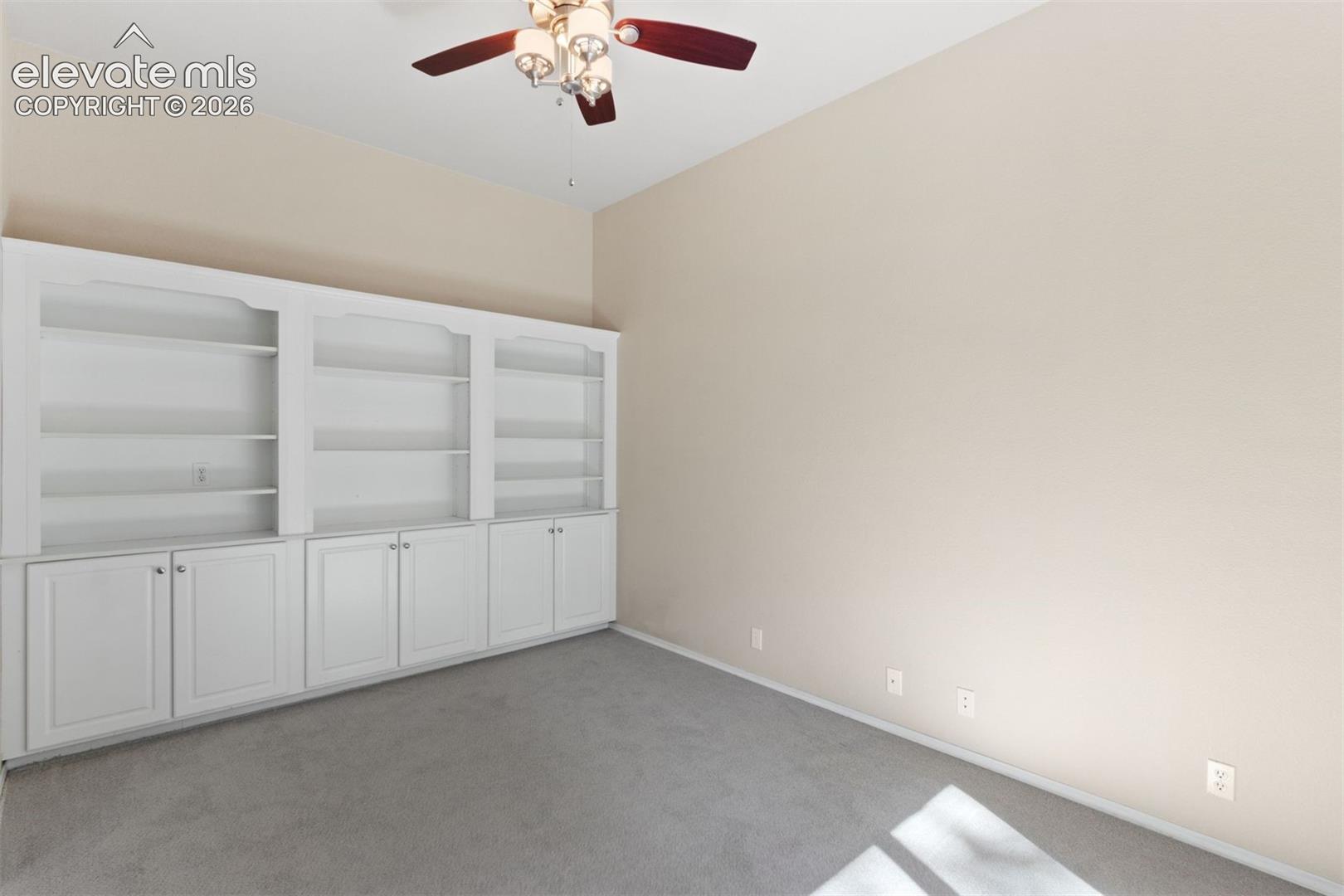Dedicated main level office with french doors and ceiling fan