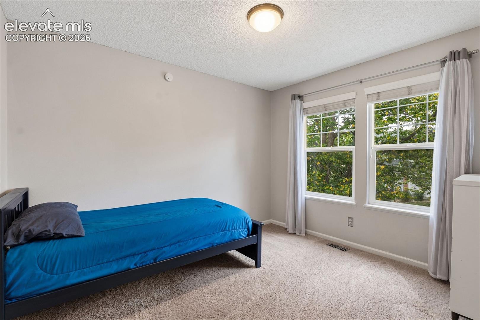 Light-toned walls, recessed lighting, and dual windows with white trim