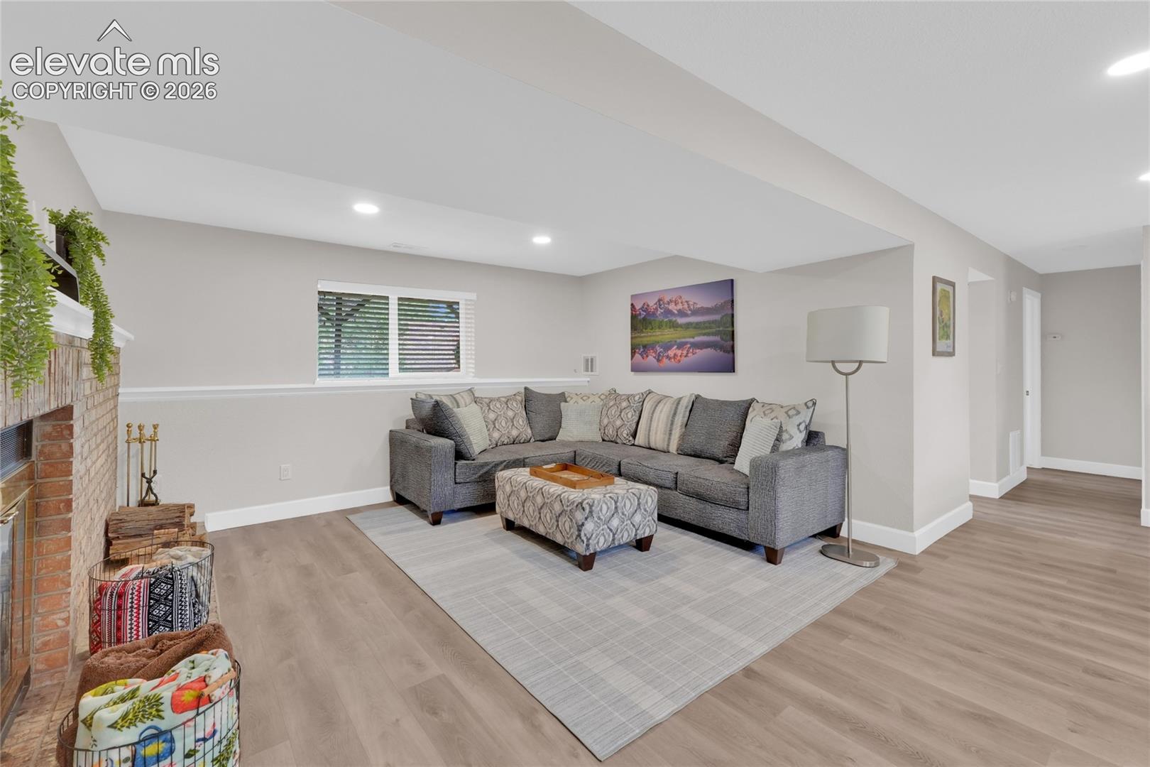 Lower level family room with fireplace and recessed lighting througout.