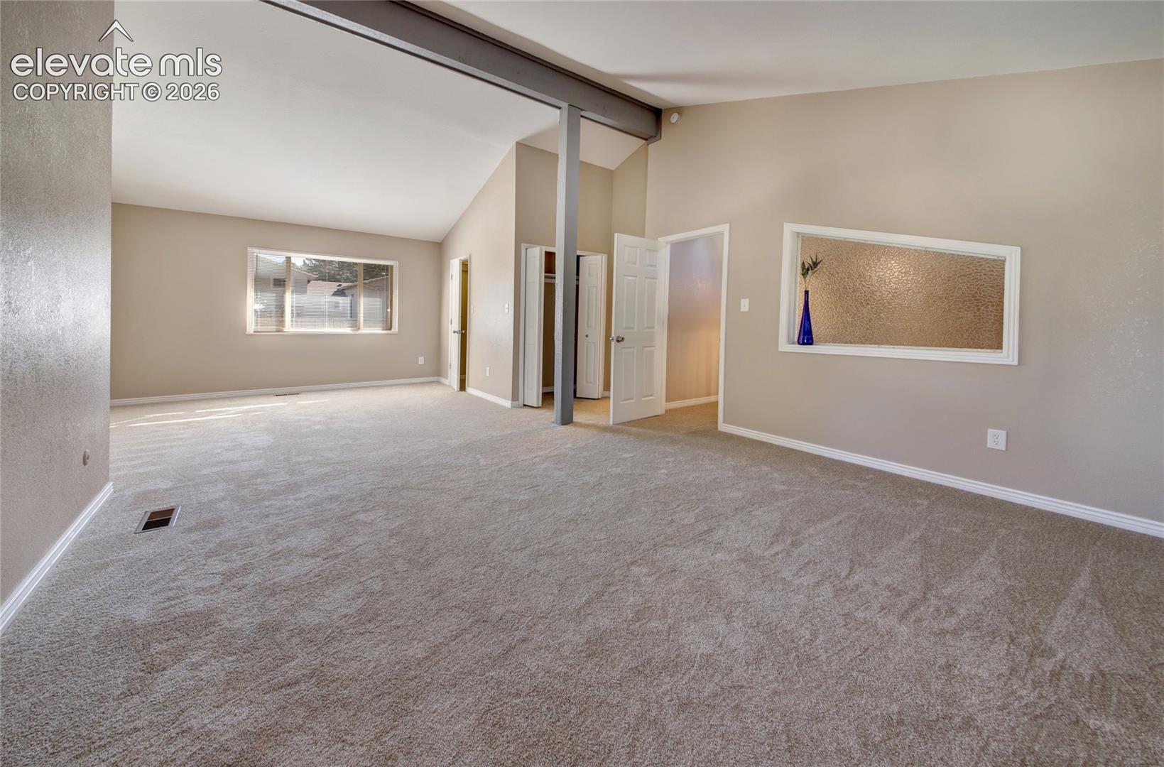 Primary bedroom with double walk in closets, and obscured, rain glass, side light window to let more light in!