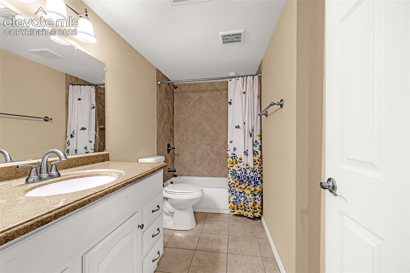 Vanity with integrated sink, brushed nickel faucet, and a large mirror