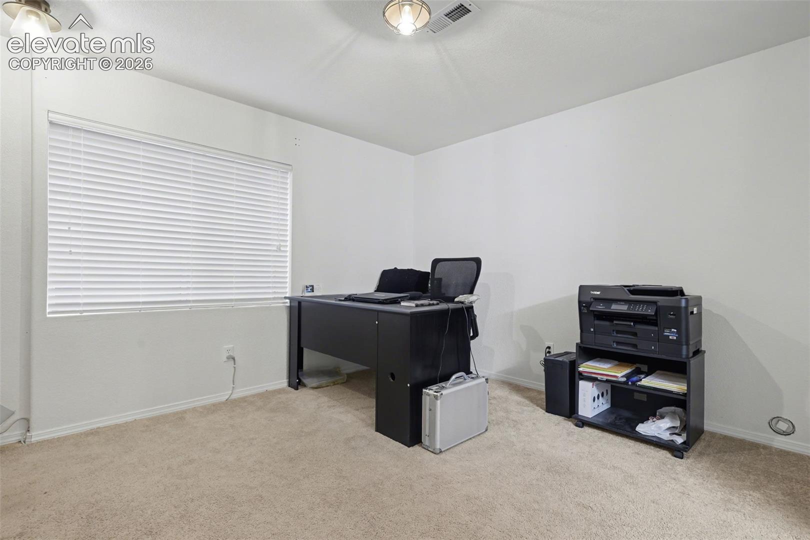 Family room in basement, currently set up as an office.