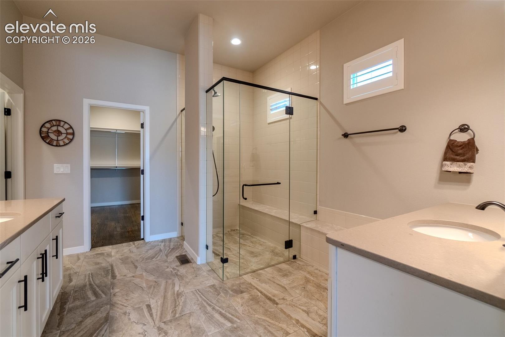 Contemporary bathroom with a glass-enclosed shower featuring a built-in bench