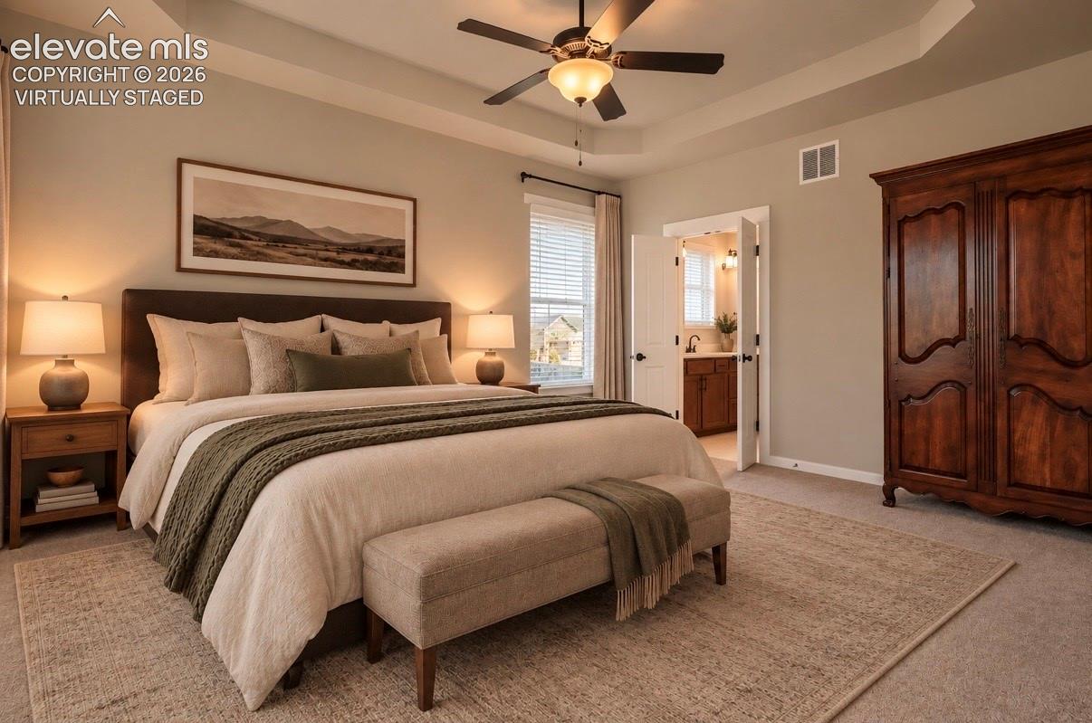 Virtually Staged Primary Bedroom, Tray ceiling featuring a central ceiling fan with integrated lighting, neutral wall paint, and window with slat blinds