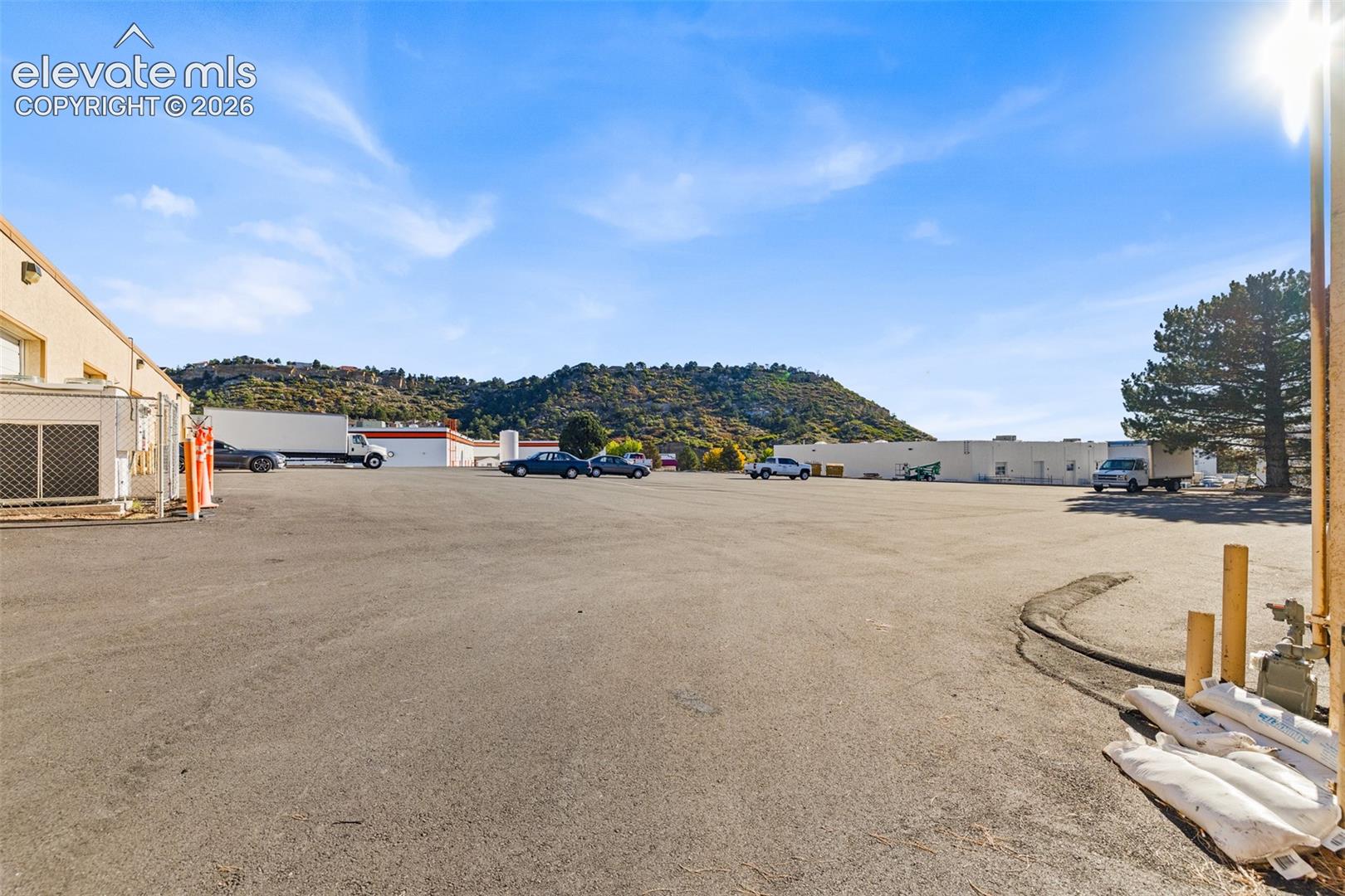 Expansive asphalt parking area with mountain backdrop