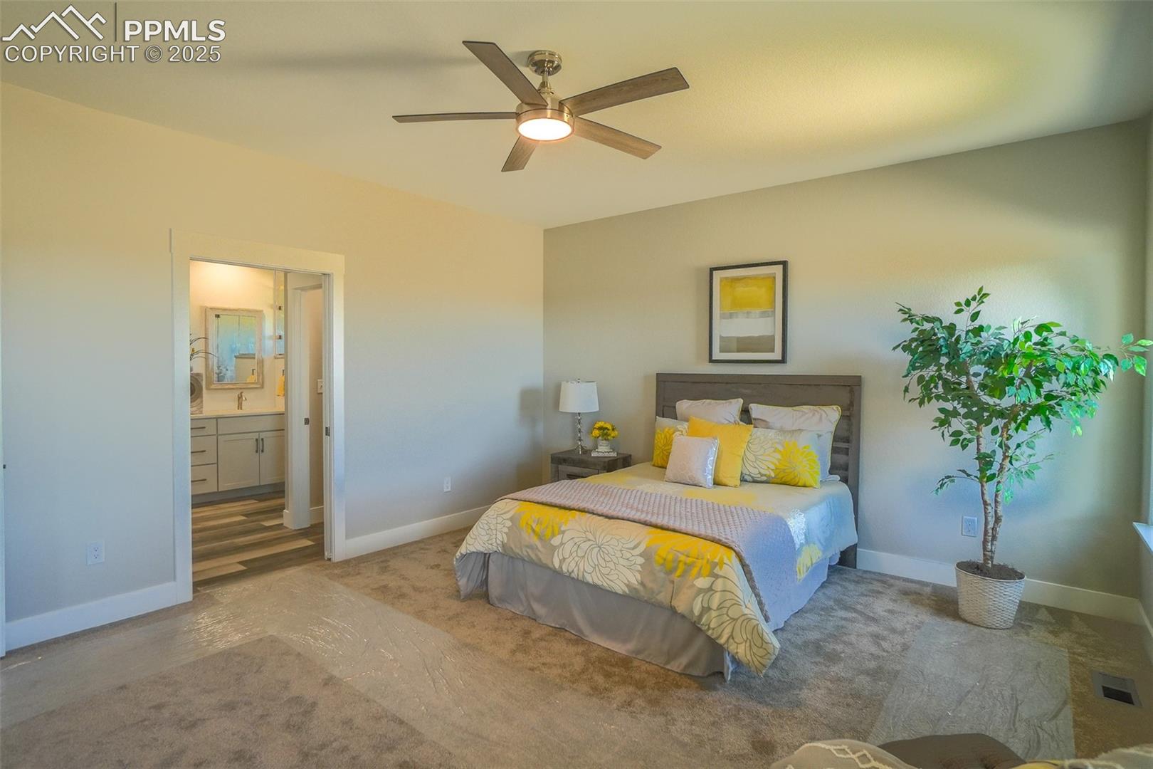 Bedroom featuring wood-type flooring, connected bathroom, and ceiling fan