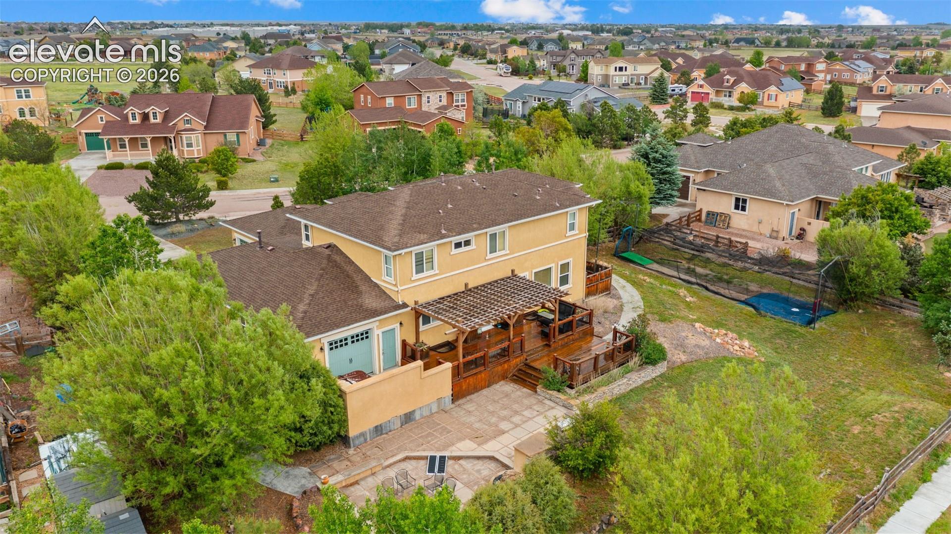 Two-story residence with a stucco exterior and shingle roof