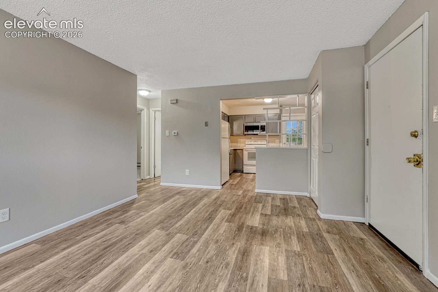 Wood-finish flooring throughout, light gray wall paint, and white trim