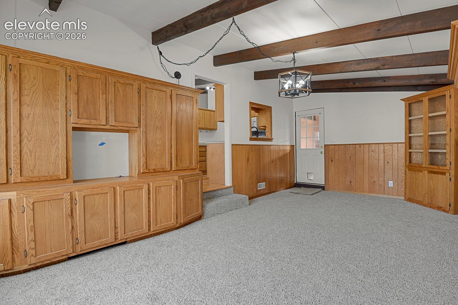 Family room with built ins and beamed ceilings