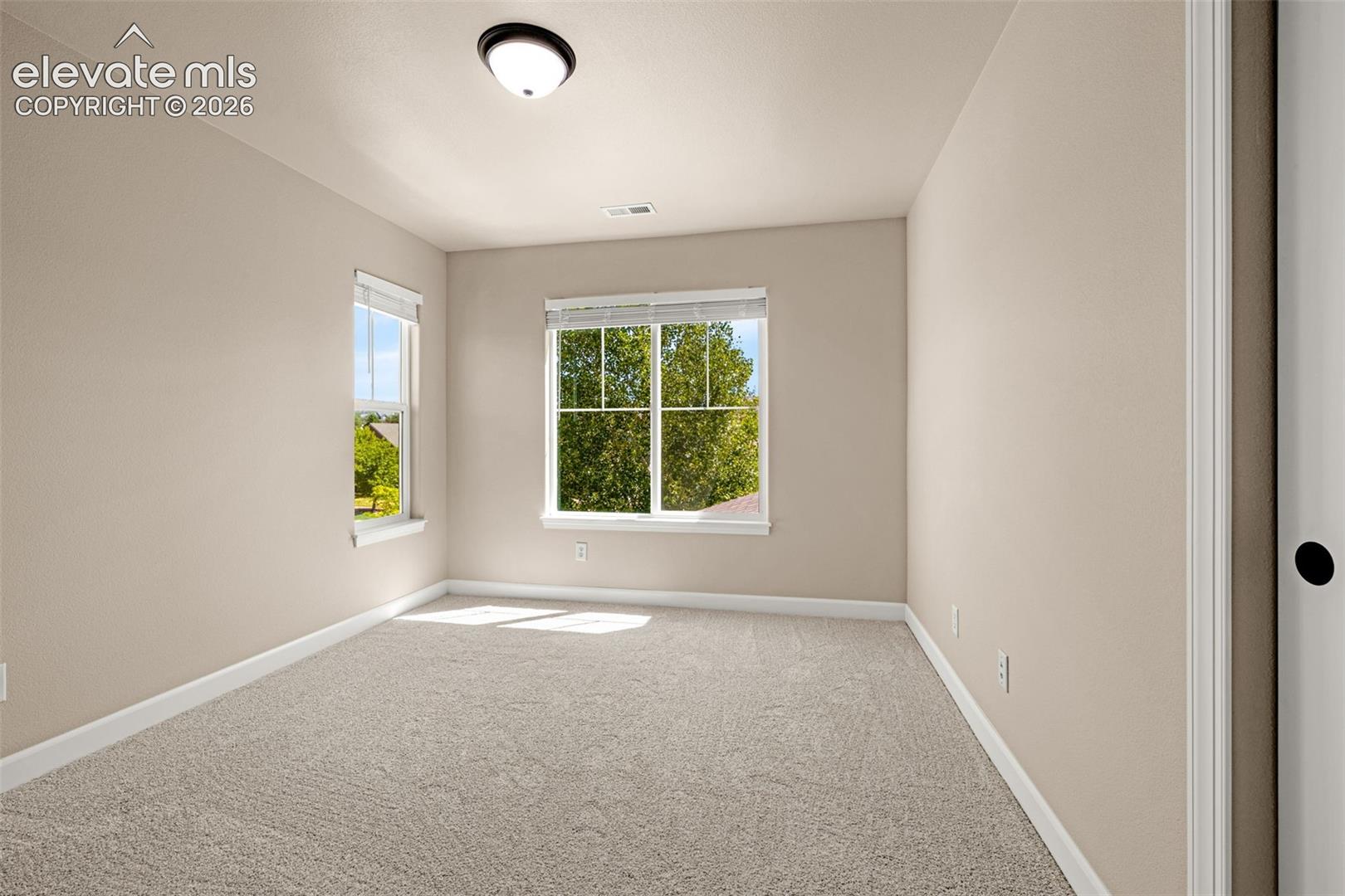 Upper level Bedroom 2; new carpet, new blinds, new baseboards, new paint, new lighting and a wall-to-wall closet.  