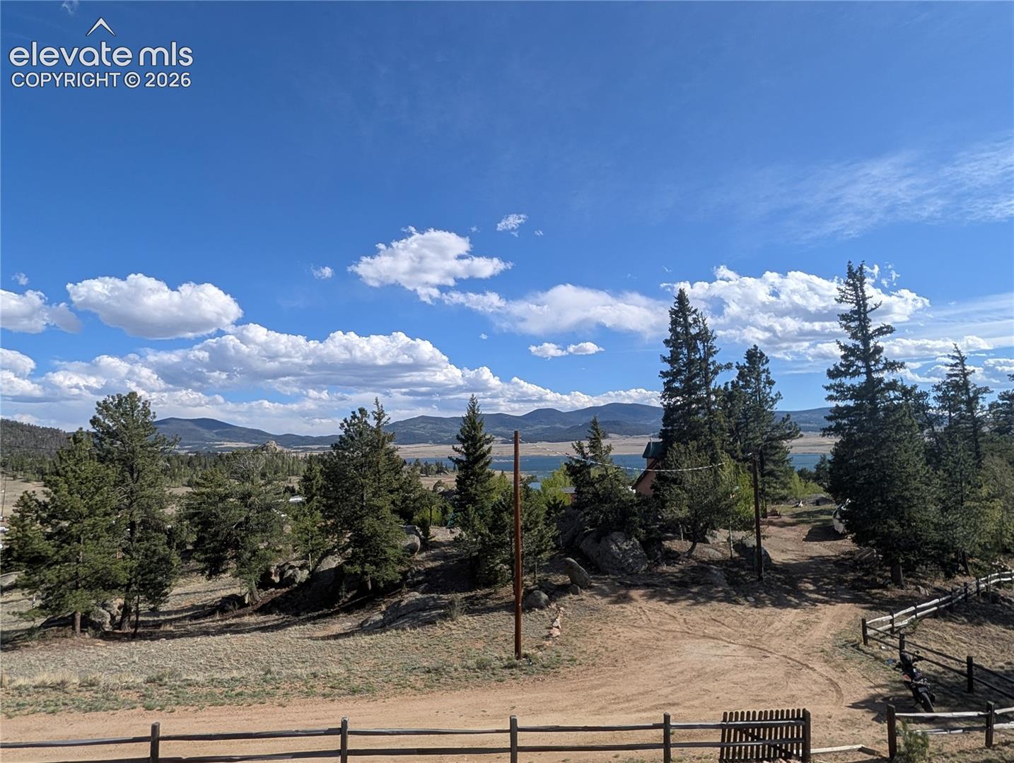 Expansive natural landscape featuring a distant body of water and mountain range