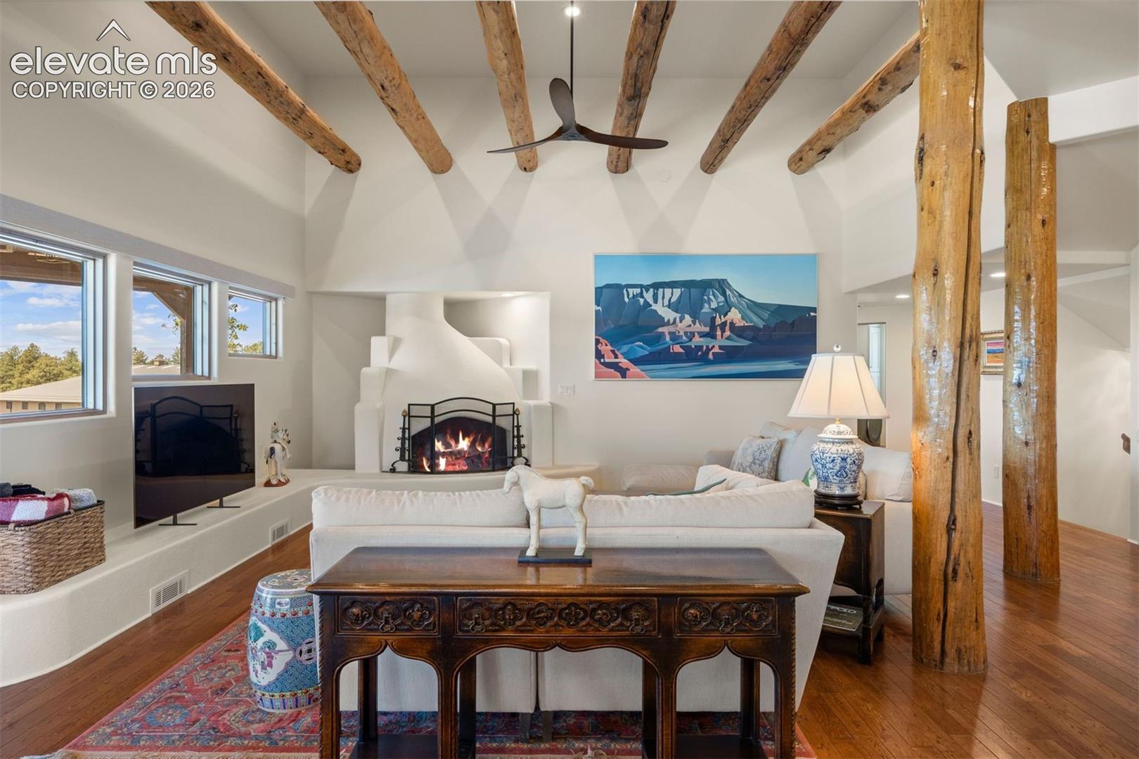 Double doors open from the foyer into an expansive open great room flowing seamlessly to the kitchen, dining area, staircase, and main hallway beyond. 
