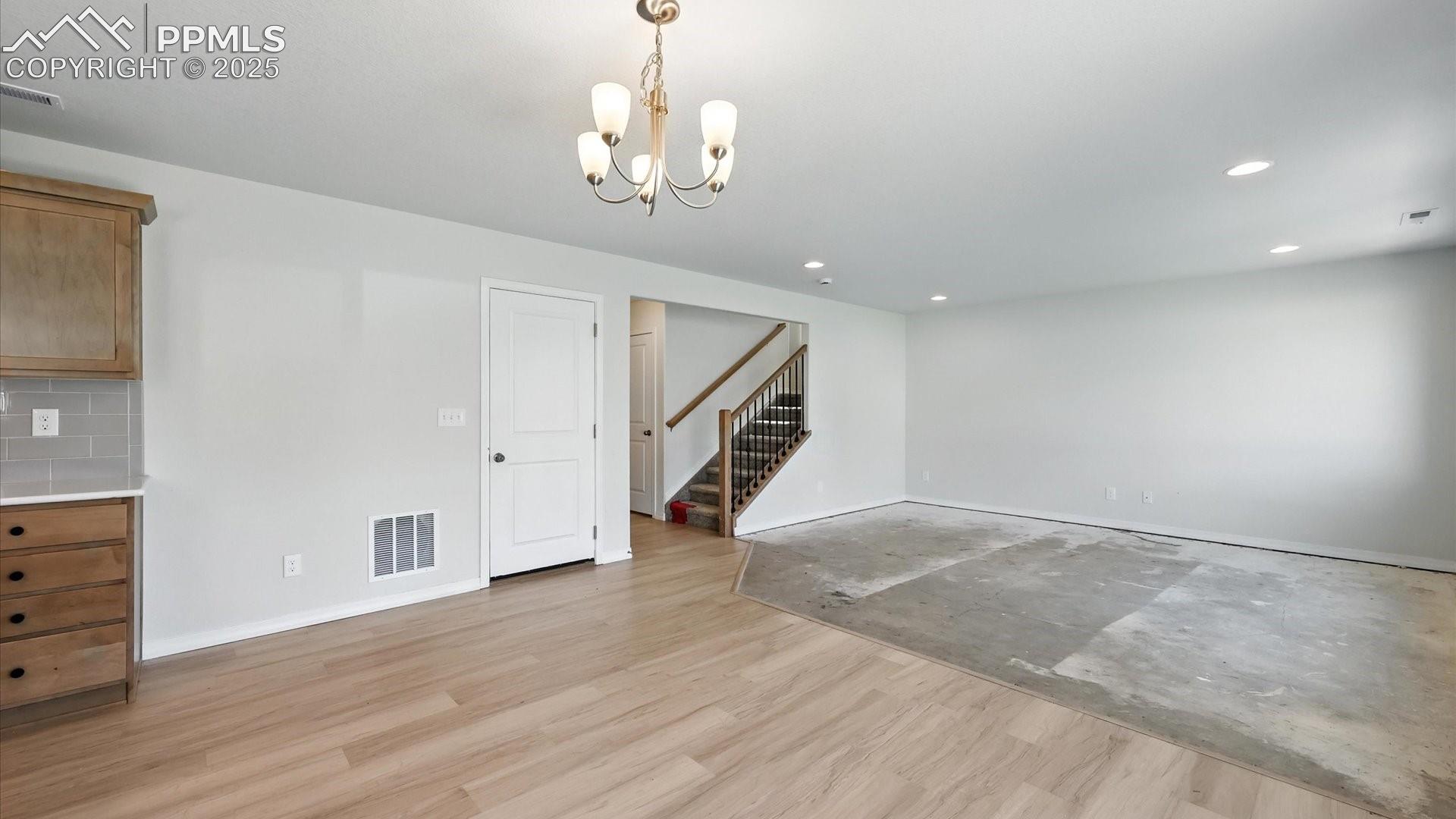 View of the Dining Area, Living Room, and stairs to the upper level.