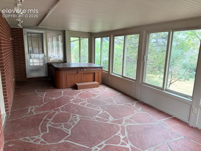 Lovely sunroom off the living room and the hot tub stays!