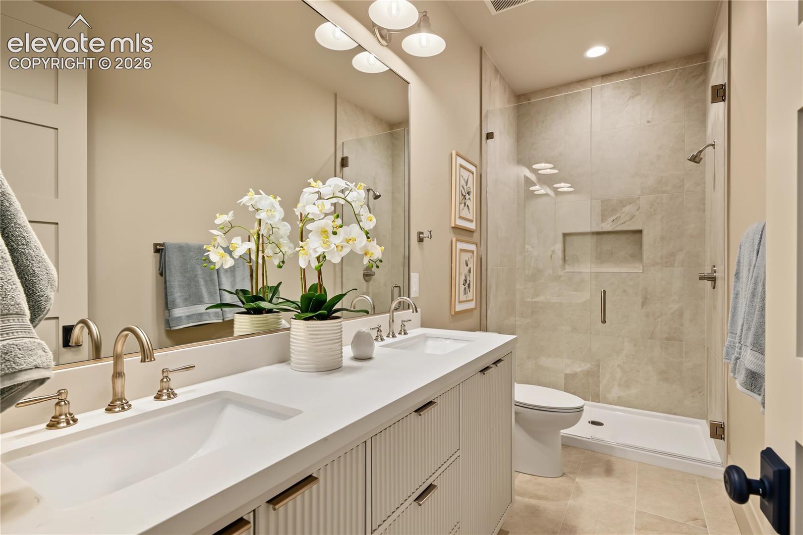 Large double vanity with glass walk-in shower, basement