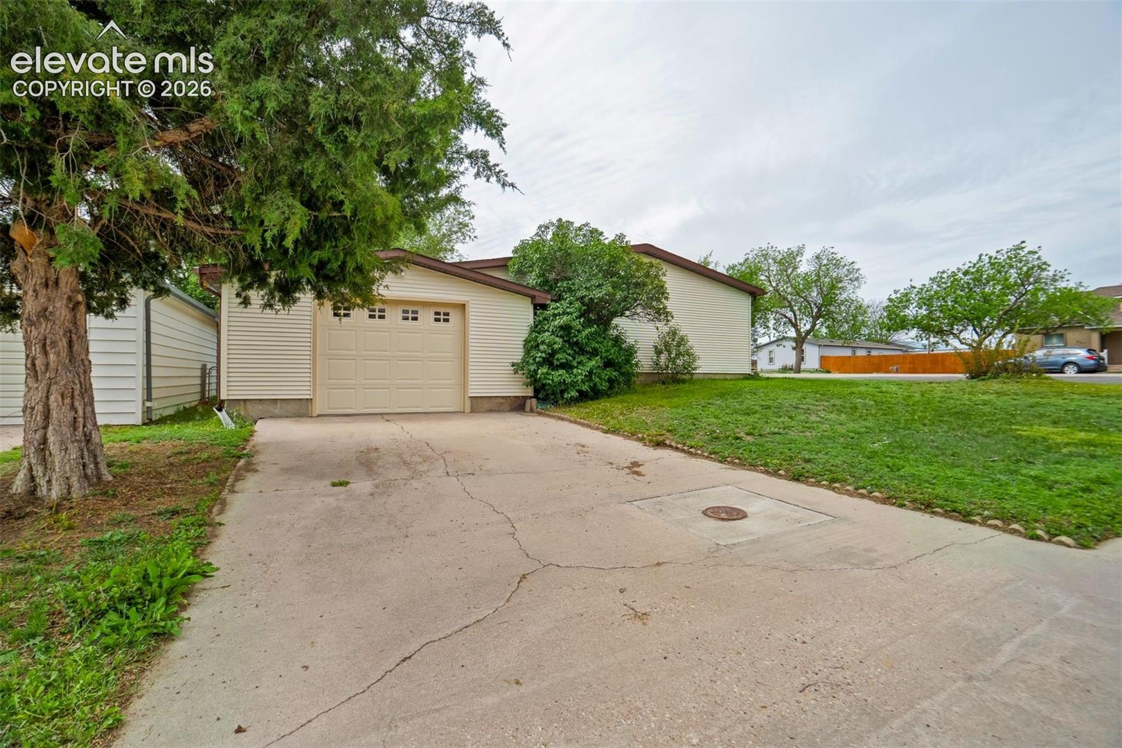Concrete driveway provides additional off-street parking and easy access to the attached garage.
