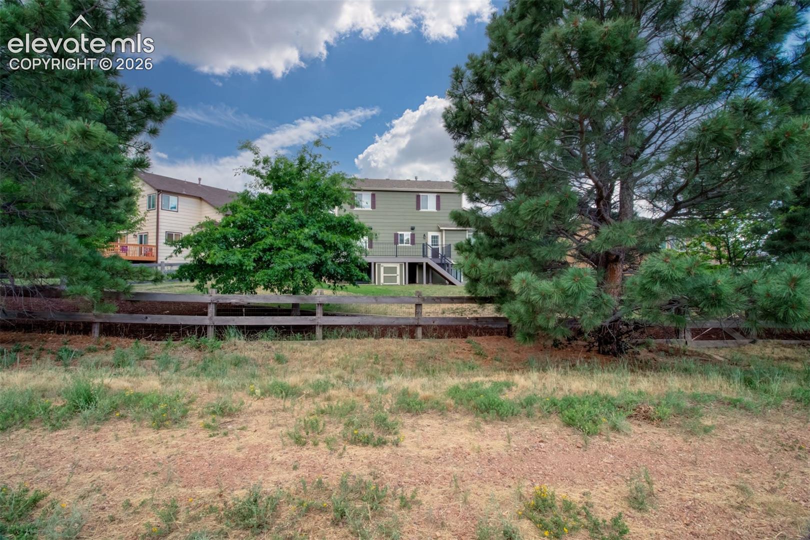 Open Space behind the home with a trail