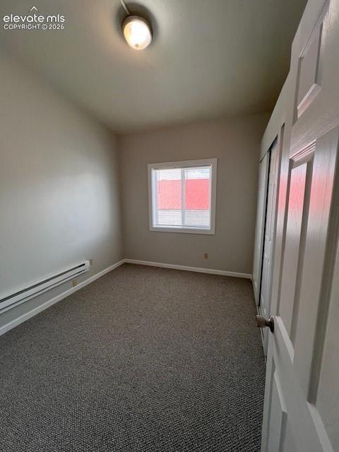 Neutral-toned interior space featuring wall-to-wall carpeting, a sliding door closet, and a single-hung window