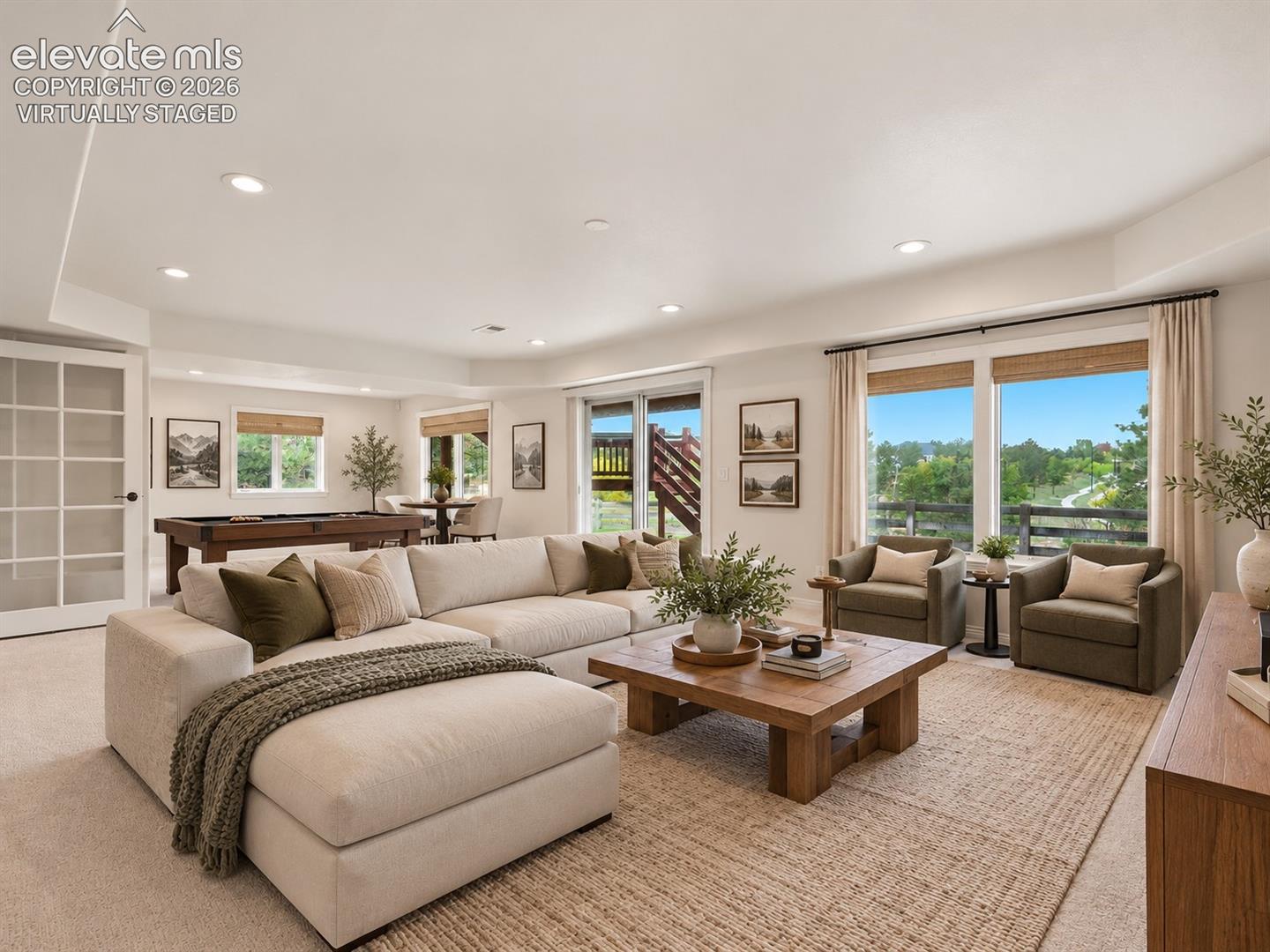 Neutral-toned carpeted flooring, recessed lighting, expansive glass sliding doors, multipane glass-panel door, and large windows with integrated hardware- virtually staged