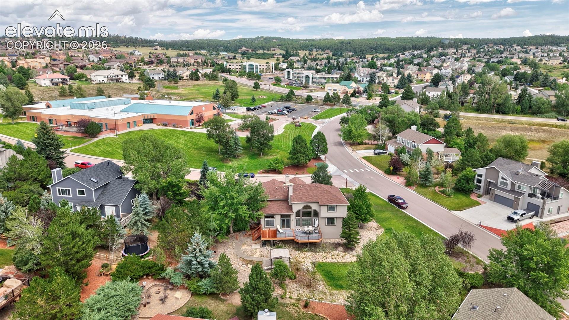 Aerial perspective showcasing a residential community with varied architectural styles, and mature trees